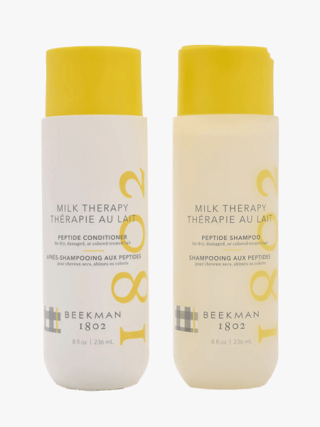 Beekman 1802 Milk Therapy Peptide Shampoo and Conditioner on a light gray background